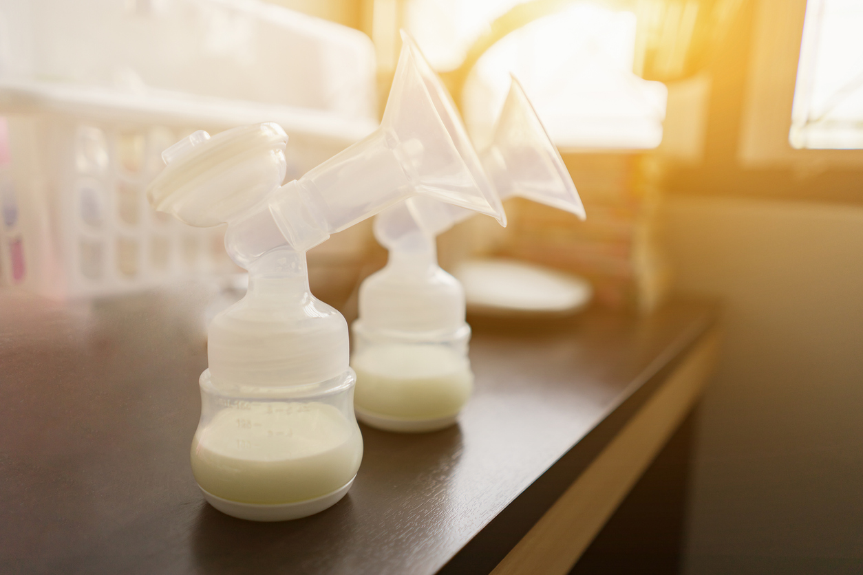 Baby bottles with pump flanges and expressed milk in them